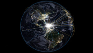 Satellite-style view of the Western Hemisphere at night, with North and South America lit by city lights and a brilliant white hub over Central America sending glowing lines of connection across the oceans.