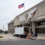 Workers loading boxes at Department of Energy building