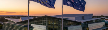 EU and Australian flags over modern building